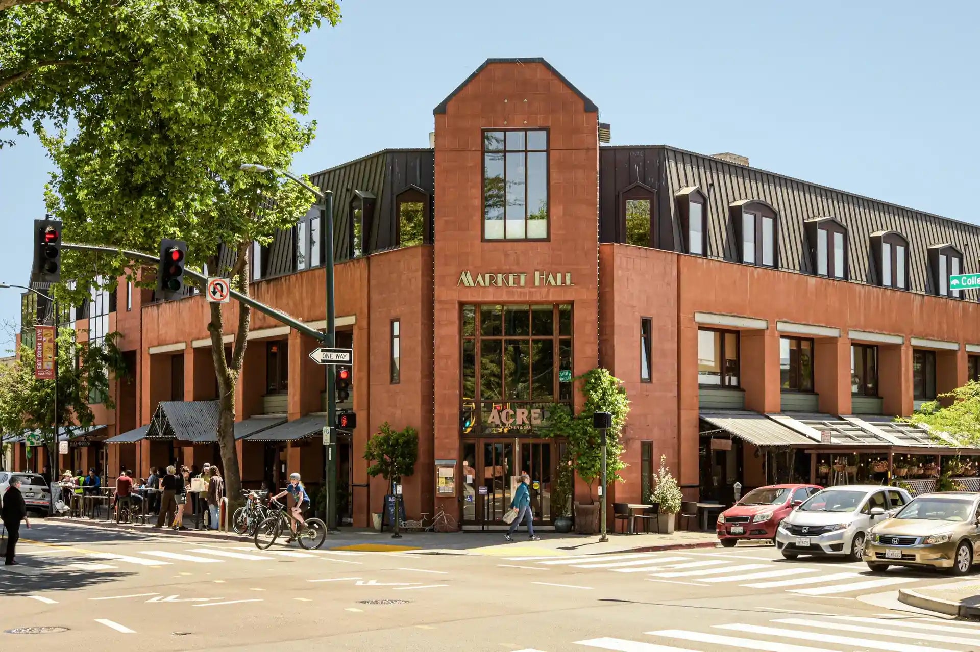 Brick building with 'Waffle Haus' and 'Mac's' signs on a city street.