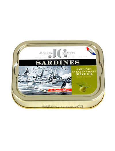 A tin can of Les Mouettes d'Arvor sardines in extra virgin olive oil with a label depicting a fishing scene.